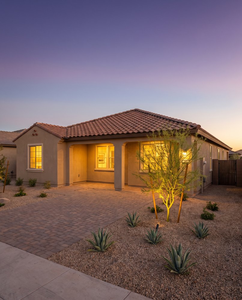 Illustrative Arizona stucco home with a tile roof at dusk